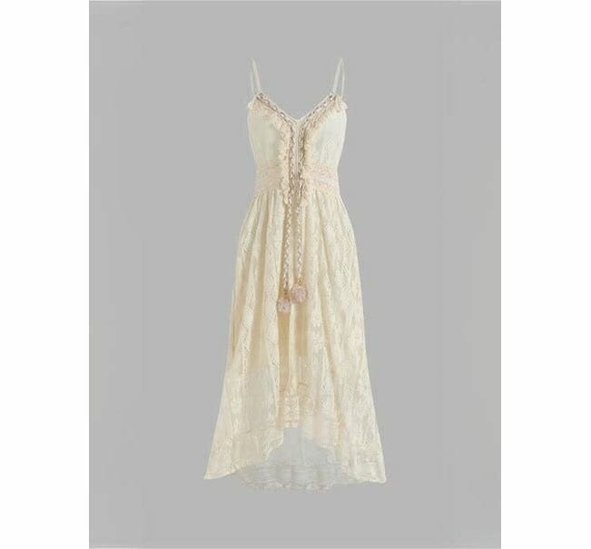 Lacy white/creme dress with grey background.