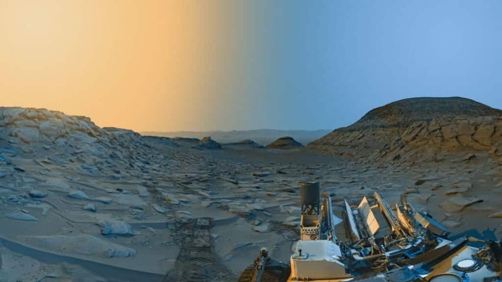 On April 8, 2023, NASA's Curiosity Mars rover utilized its monochrome navigation cameras to record panoramic views of "Marker Band Valley" during two different periods of the day. To enhance the visual appeal, a blend of both panoramas was infused with color, resulting in an artistic rendition of the landscape.