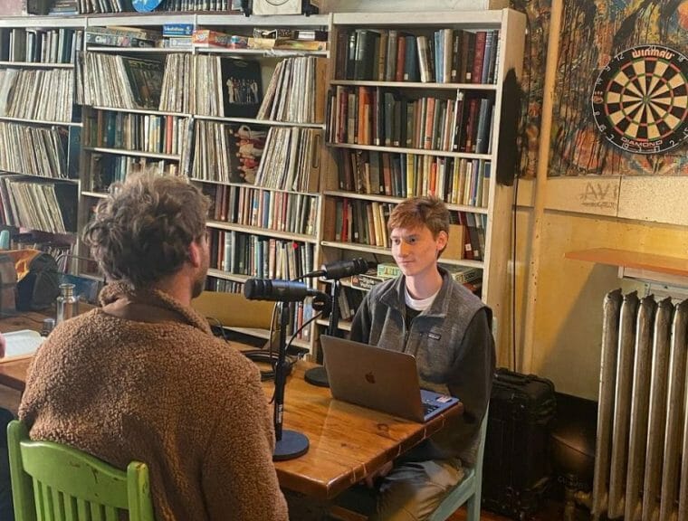 Matt Nusom and the owner of Lake Drum Brewing Company from Geneva, NY sitting at a table during a podcast episode. 