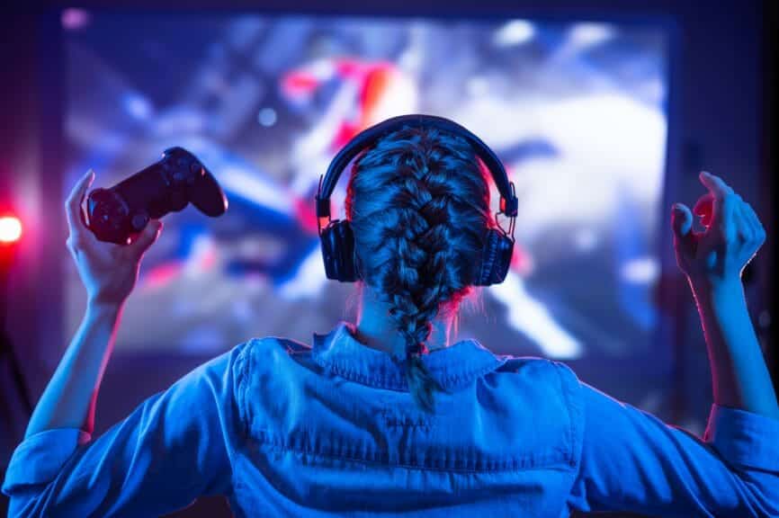 Woman cheering and looking at computer screen