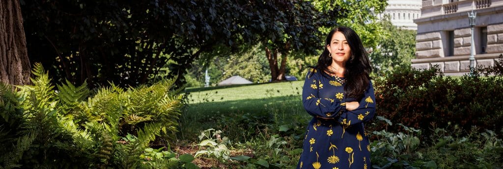 Ada Limón, the 24th Poet Laureate Consultant in Poetry to the Library of Congress, standing by a park in the background.