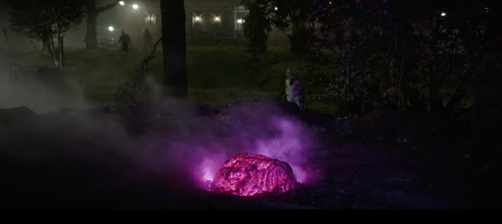 A brightly-colored asteroid with a magenta glow stands in the middle of the image, with a dog staring at it and people running toward it. 