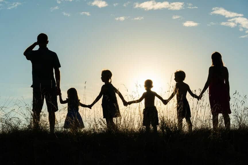 Family silhoutted against the sunset