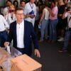 Spain's opposition leader gestures to a ballot box.