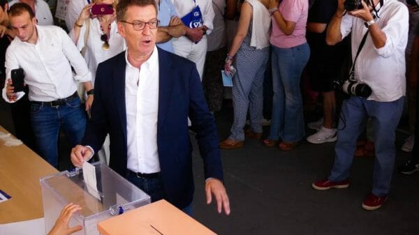 Spain's opposition leader gestures to a ballot box.