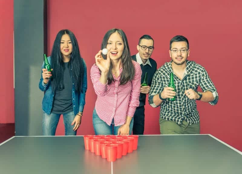 Friends playing beer pong