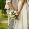 Man and woman holding hands at their wedding