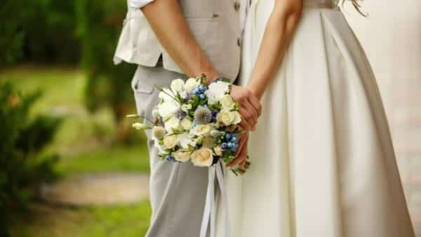 Man and woman holding hands at their wedding