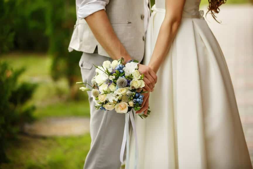 Man and woman holding hands at their wedding