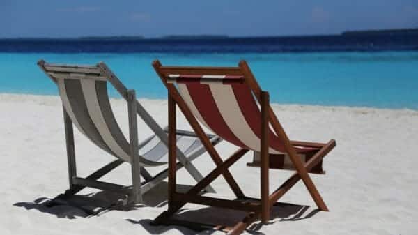 Two sunbeds on a beach