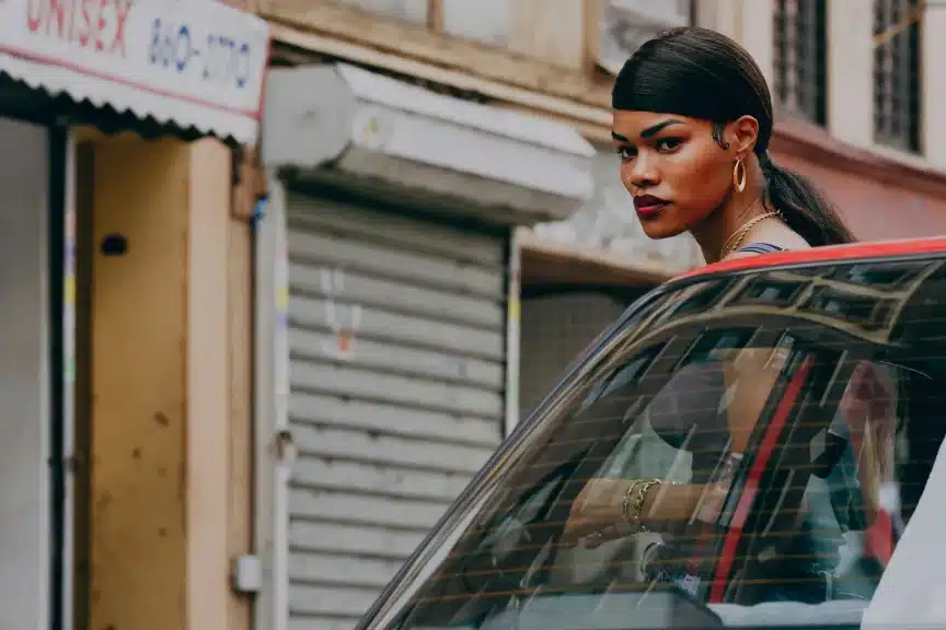 Inez de la Paz behind a car in the film "A Thousand and One."