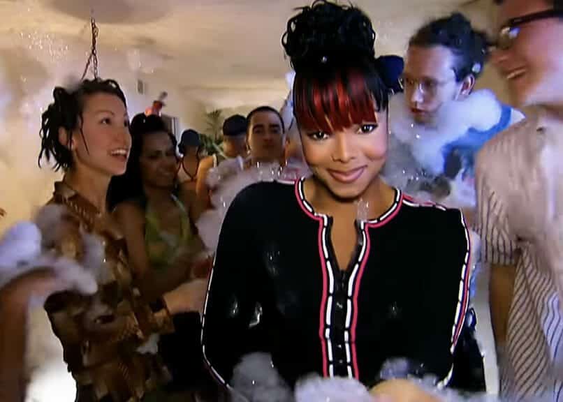 Janet Jackson standing in the middle of a party.