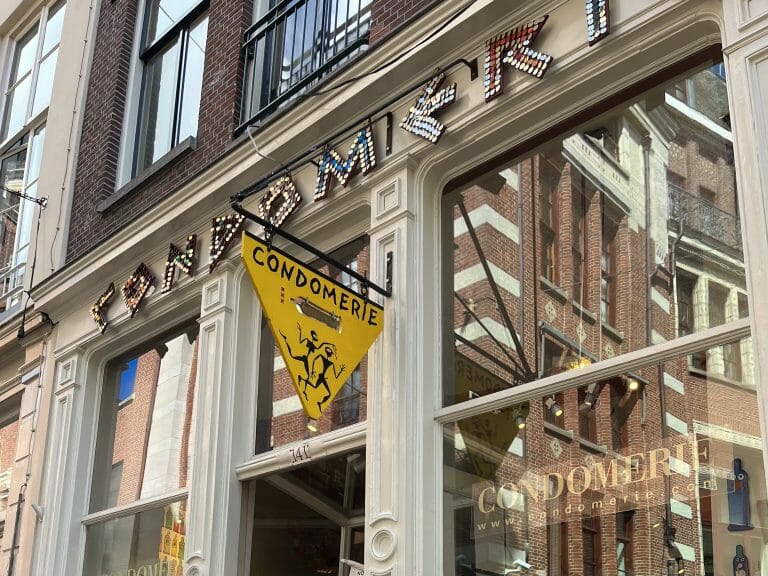 A yellow sign above a shop door in Amsterdam. 