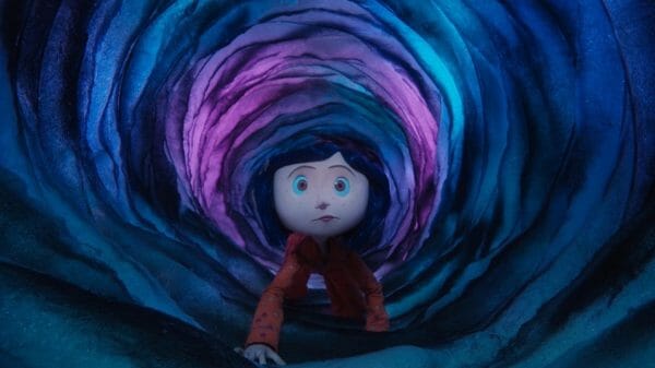 Coraline crawls through a blue and purple portal.