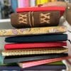 woman holding a stack of journals