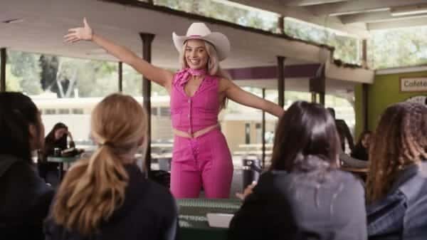 An image of the film 'Barbie' with actress Margot Robbie in the center wearing a pink cowgirl outfit.