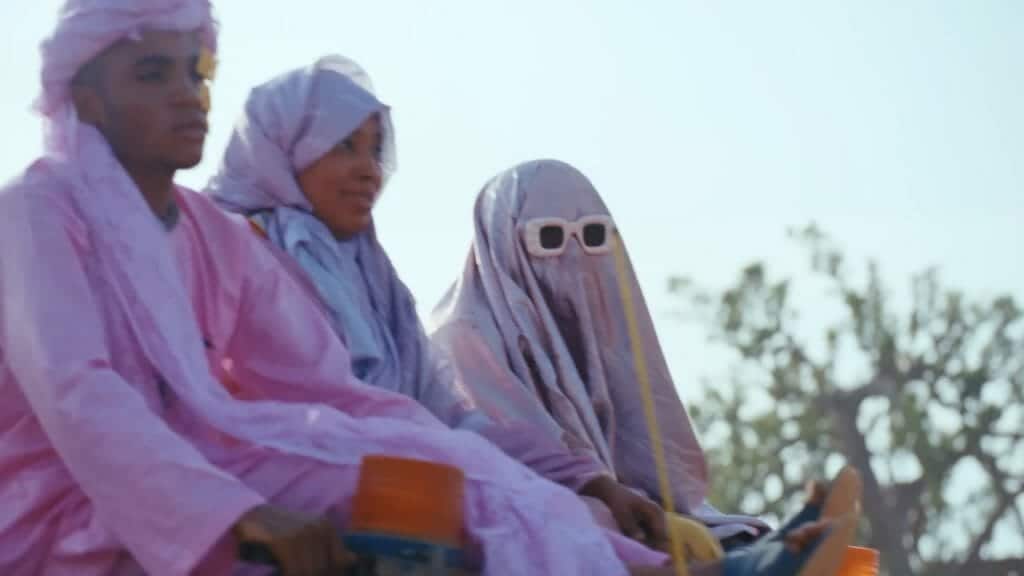 People wearing pink, perhaps religious clothing.