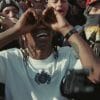 Travis Scott dancing in a crowd.