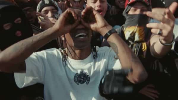 Travis Scott dancing in a crowd.