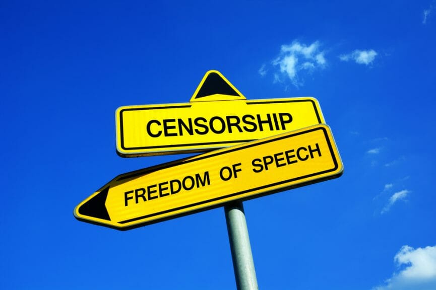 Two signs saying censorship and freedom of speech