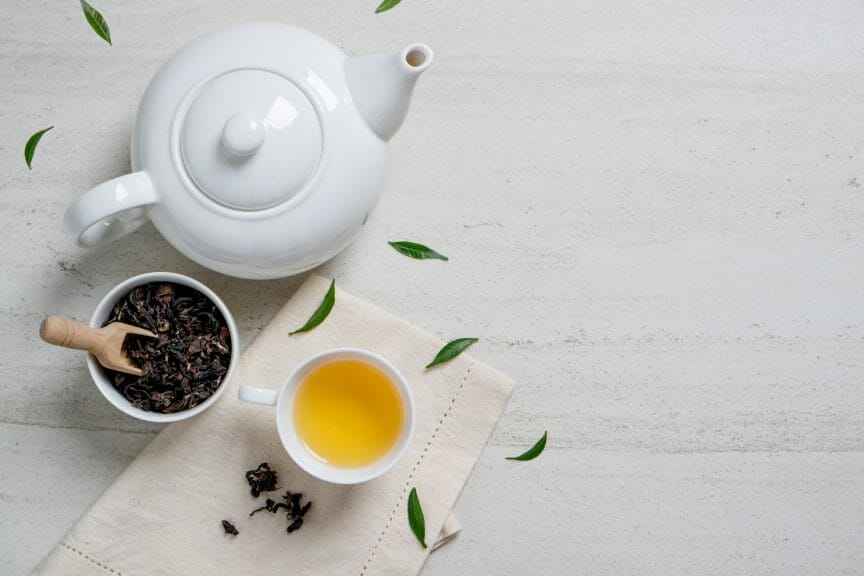 A teapot, teacup, and cup of tea leaves