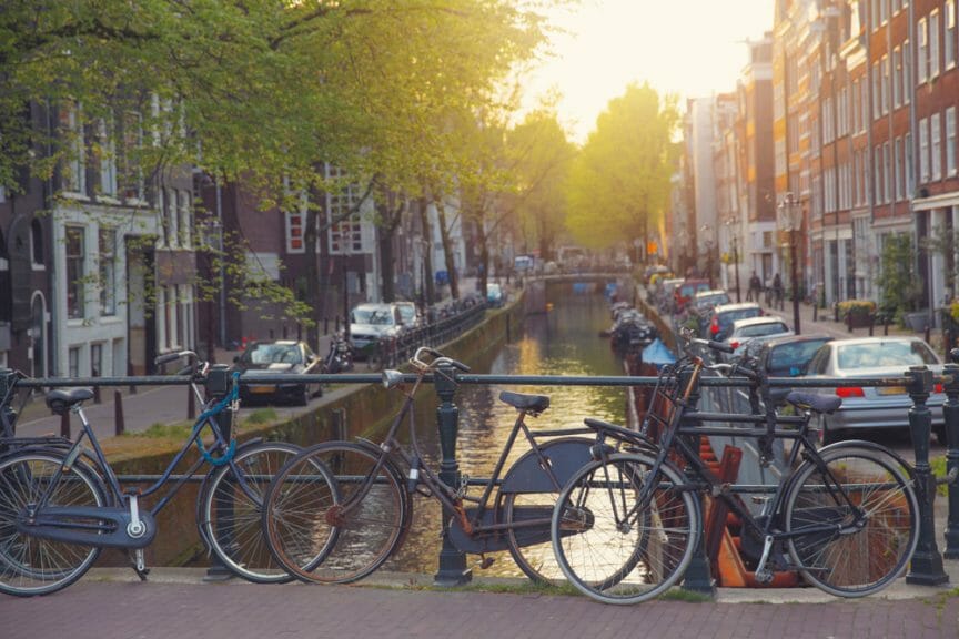 An image of bikes positioned along the canal in Amsterdam, Netherlands.
