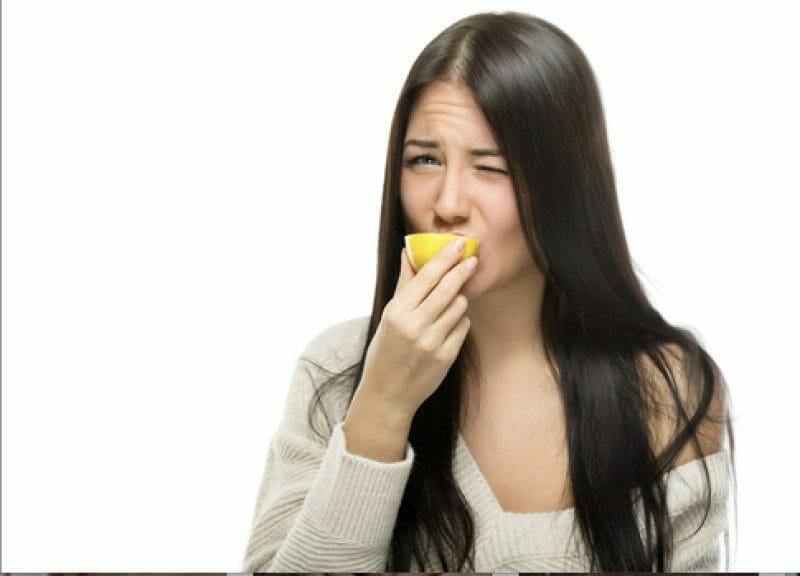 A woman biting into something sour to represent Olivia's first album 'Sour' and why some of the fans are so 'Sour' about her new music 