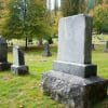 A blank gravestone in a sunny graveyard.