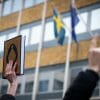 The Quran held in the air outside the Swedish Embassy.