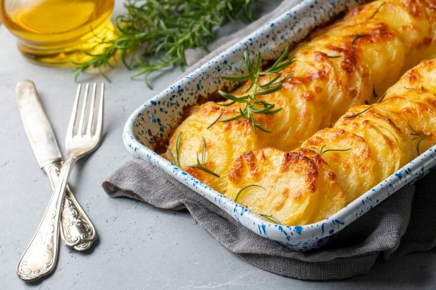 Potato au gratin with rosemary and cutlery