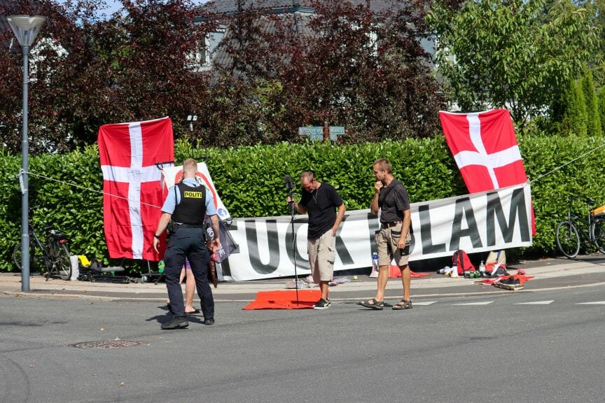 Danish patriots protesting in front of an Anti-Islam sign.
