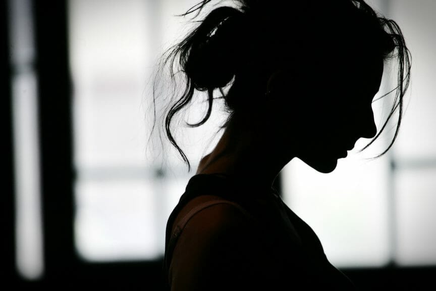 silhouette of a woman looking anxious 