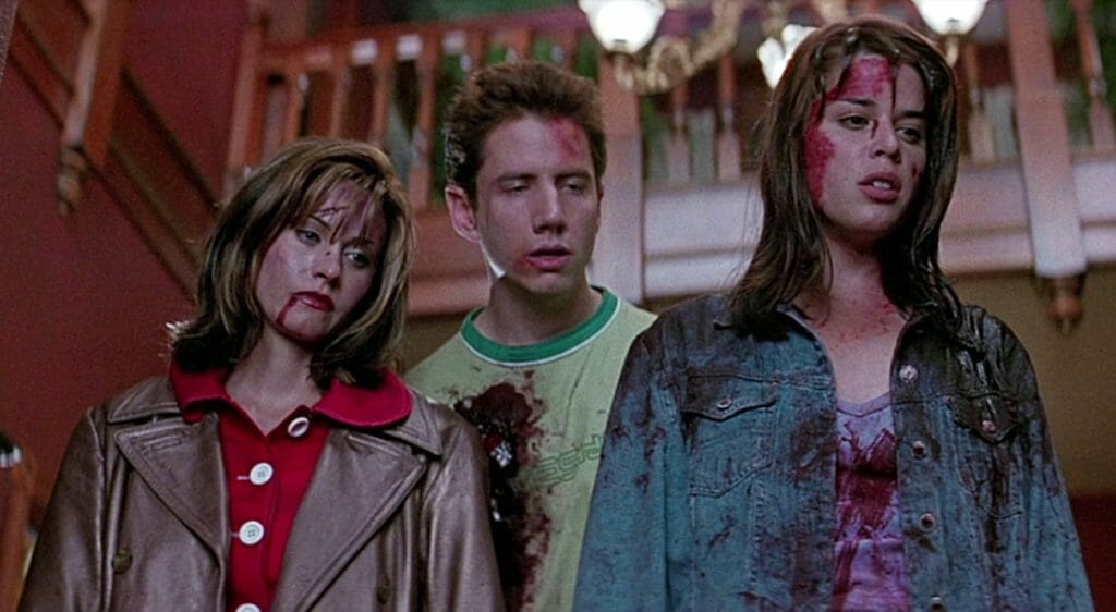 Gale, Randy, and Sidney with blood stains on their face and clothes during the final sequence of 'Scream.'