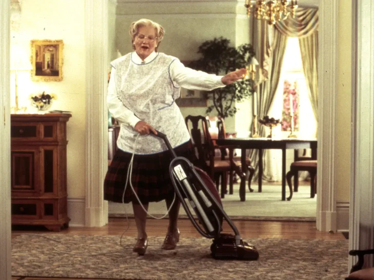 Mrs. Doubtfire hoovering the living room.