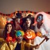 Friends pose for a photo at a Halloween party.