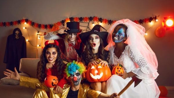 Friends pose for a photo at a Halloween party.