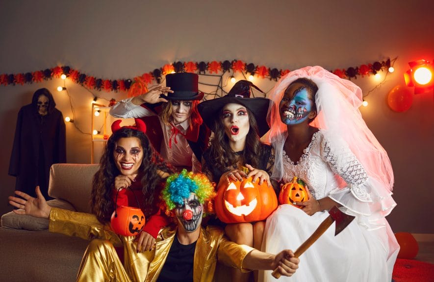 Friends pose for a photo at a Halloween party.