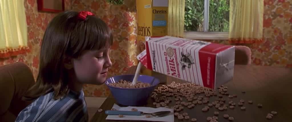 Image of Matilda using her powers to pour milk into her cereal hands free. 