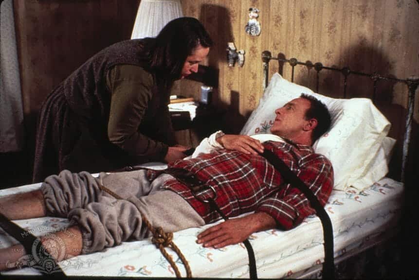 Annie ties Paul to his bed in a scene from 'Misery.'