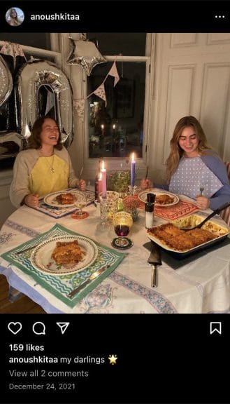 Two girls sitting down and having a homemade dinner together