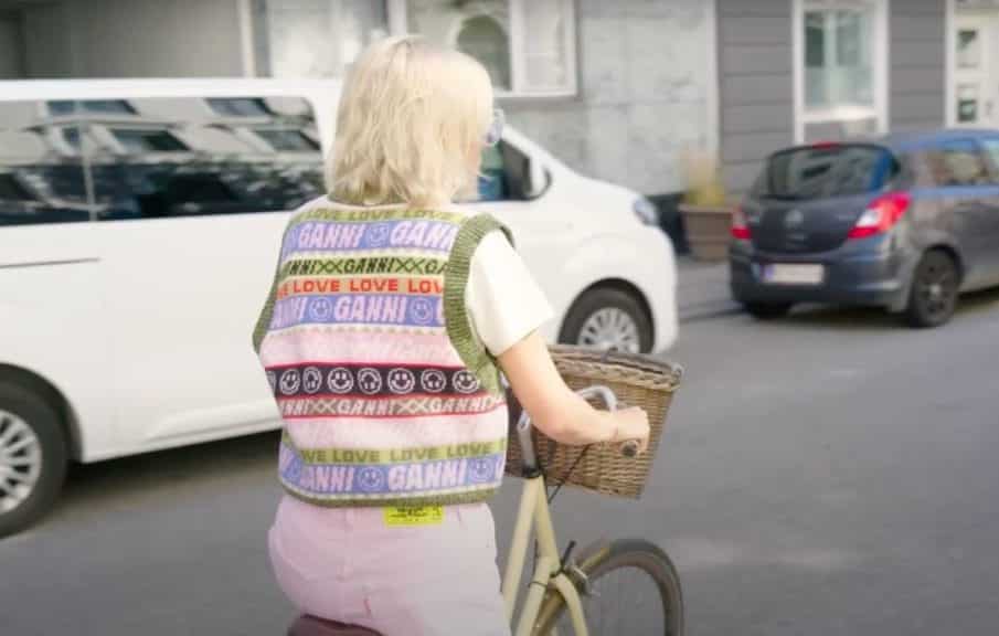 Emma Chamberlain wearing GANNI on bike