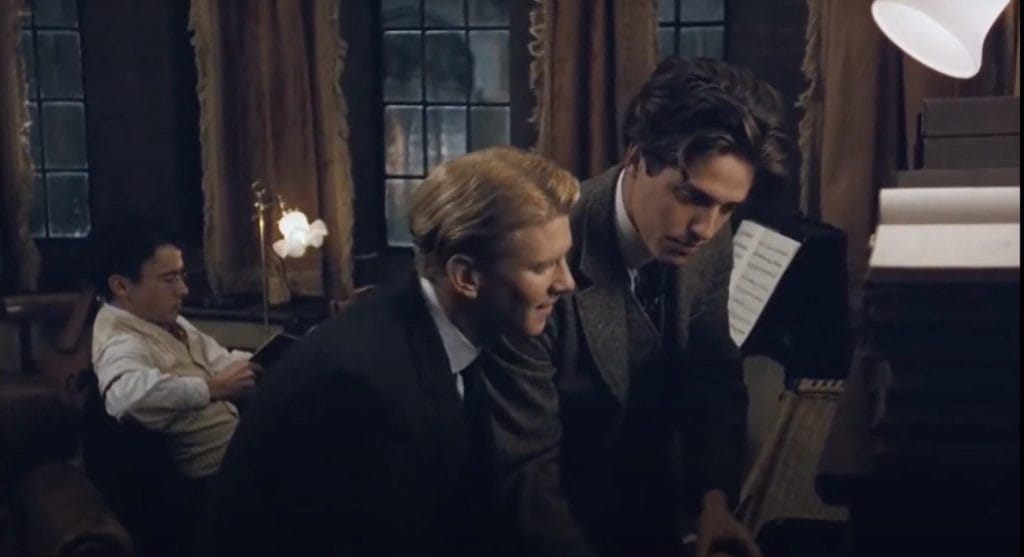 James Wilby as Maurice and Hugh Grant as Clive playing the piano