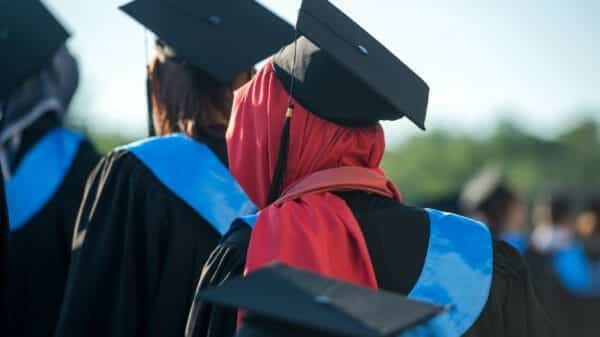 Muslim woman in red hijab graduating