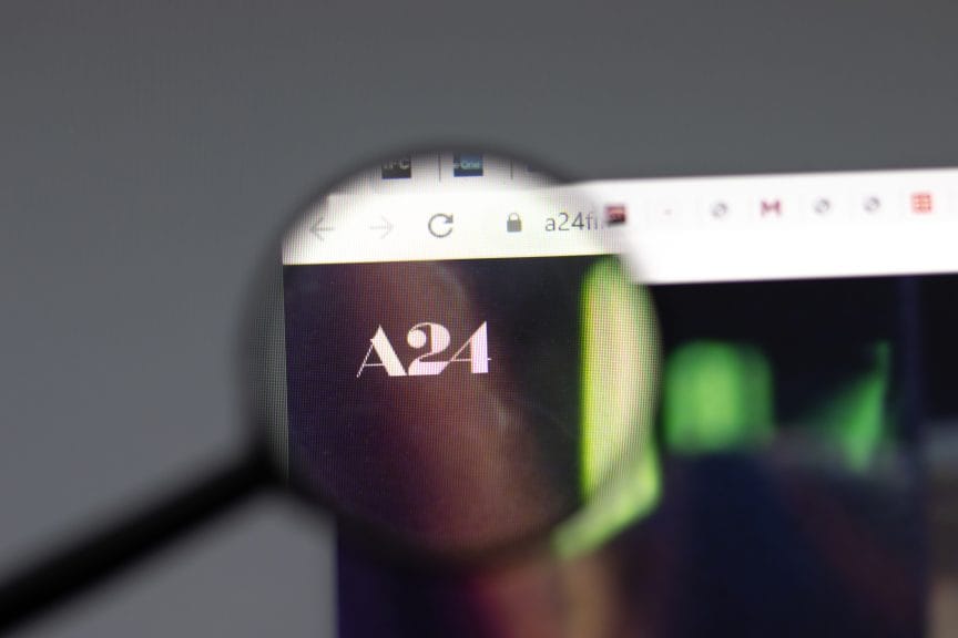 Magnifying glass focused on the A24 logo on a computer screen. 