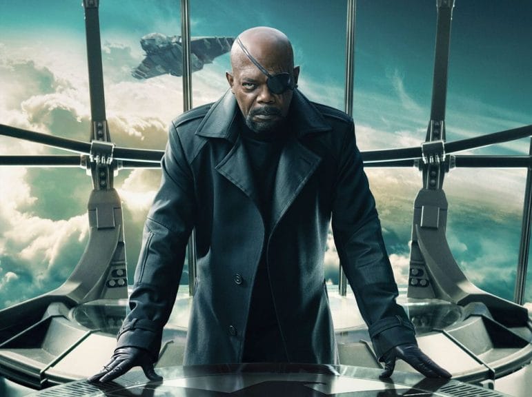 Nick Fury in a room with the window behind him.