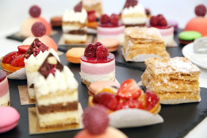 A bunch of pieces of dessert (cakes, macrons, etc)