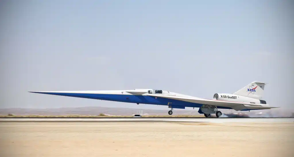 The "X-59", a plane painted with red, blue, and white stripes, flies through the sky.