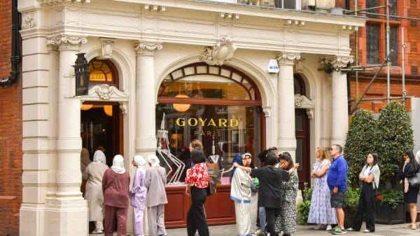 People wait outside of a Goyard store in Paris to get their hands on a luxury bag.