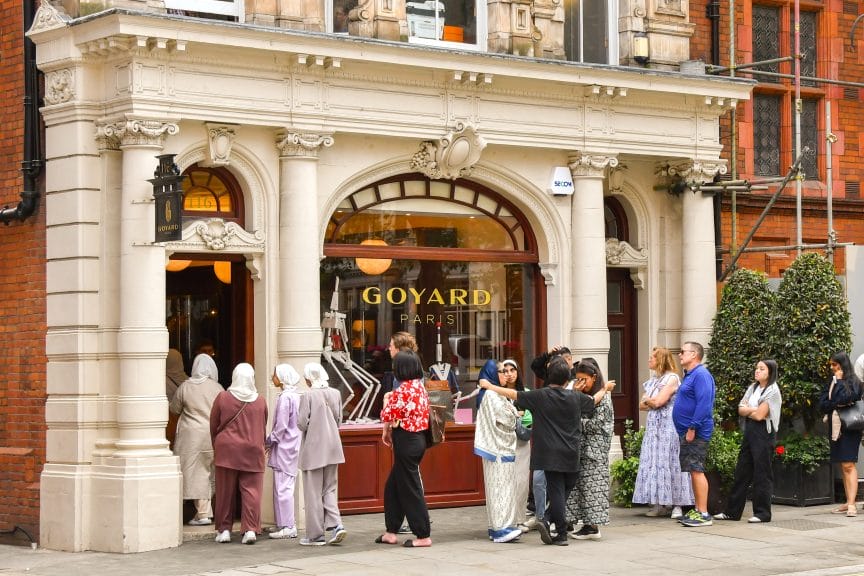 People wait outside of a Goyard store in Paris to get their hands on a luxury bag.