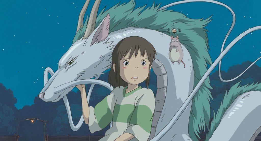 Image of the film Spirited Away with a young girl holding onto a blue and green dragon specimen. 